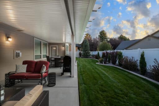 white patio cover with red and tan patio furniture in Boise, Idaho.