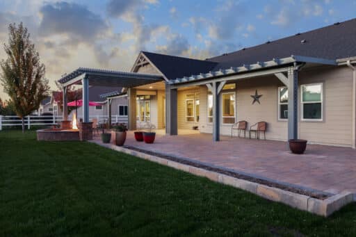 grey pergola and tan patio cover covering a fire pit in Boise, Idaho.